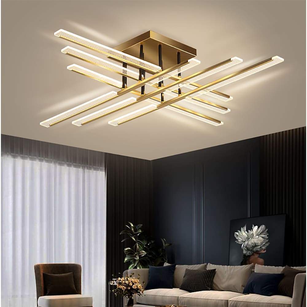 Gold cross ceiling light illuminating a stylish living room with dark accent walls.