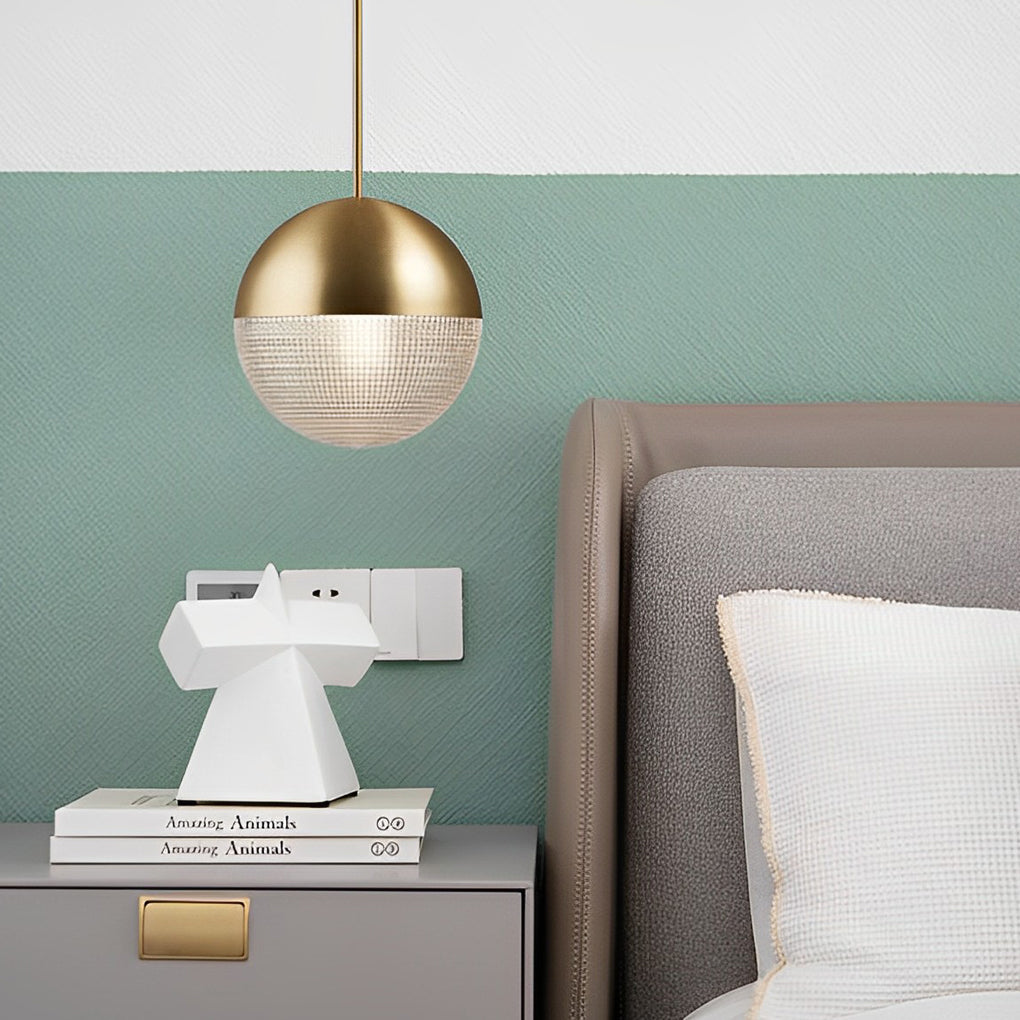 Elegant gold globe pendant light bedside fixture against a chic mint green and grey bedroom.