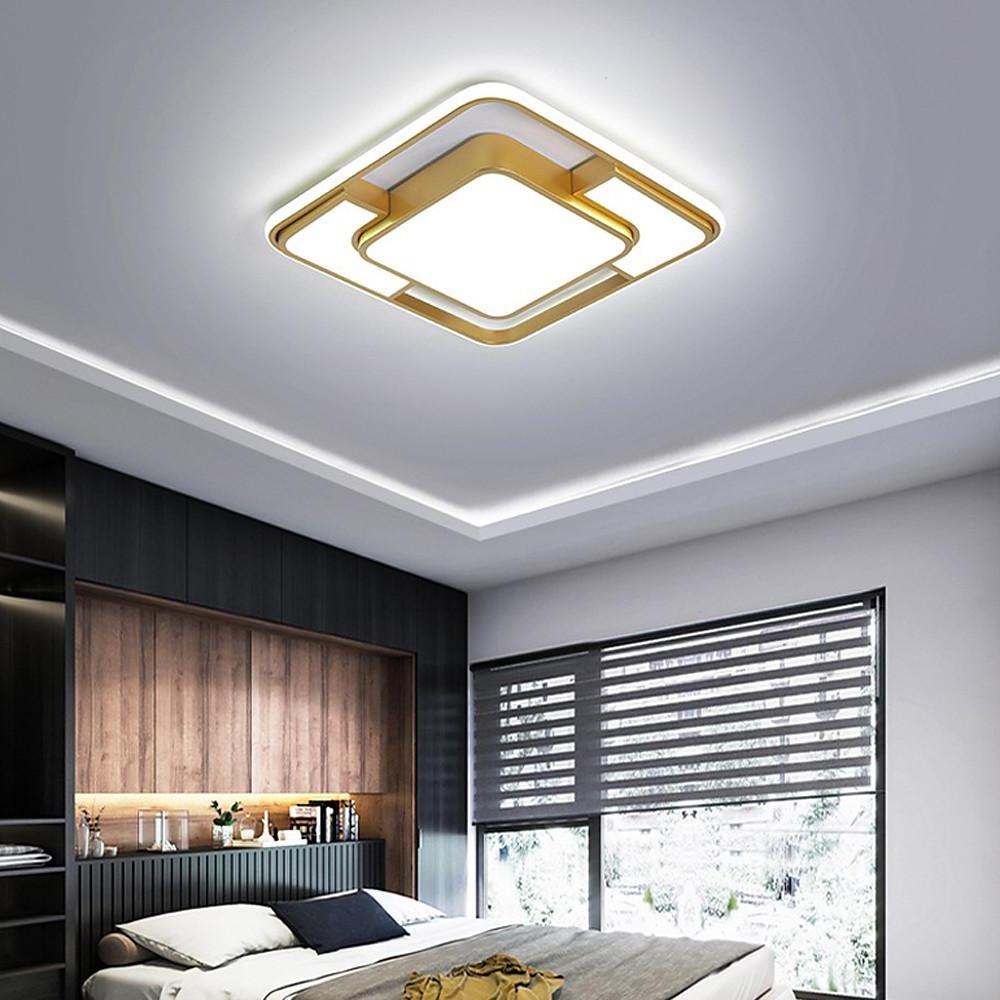 Gold square flush mount ceiling light in a bedroom with recessed ceiling design