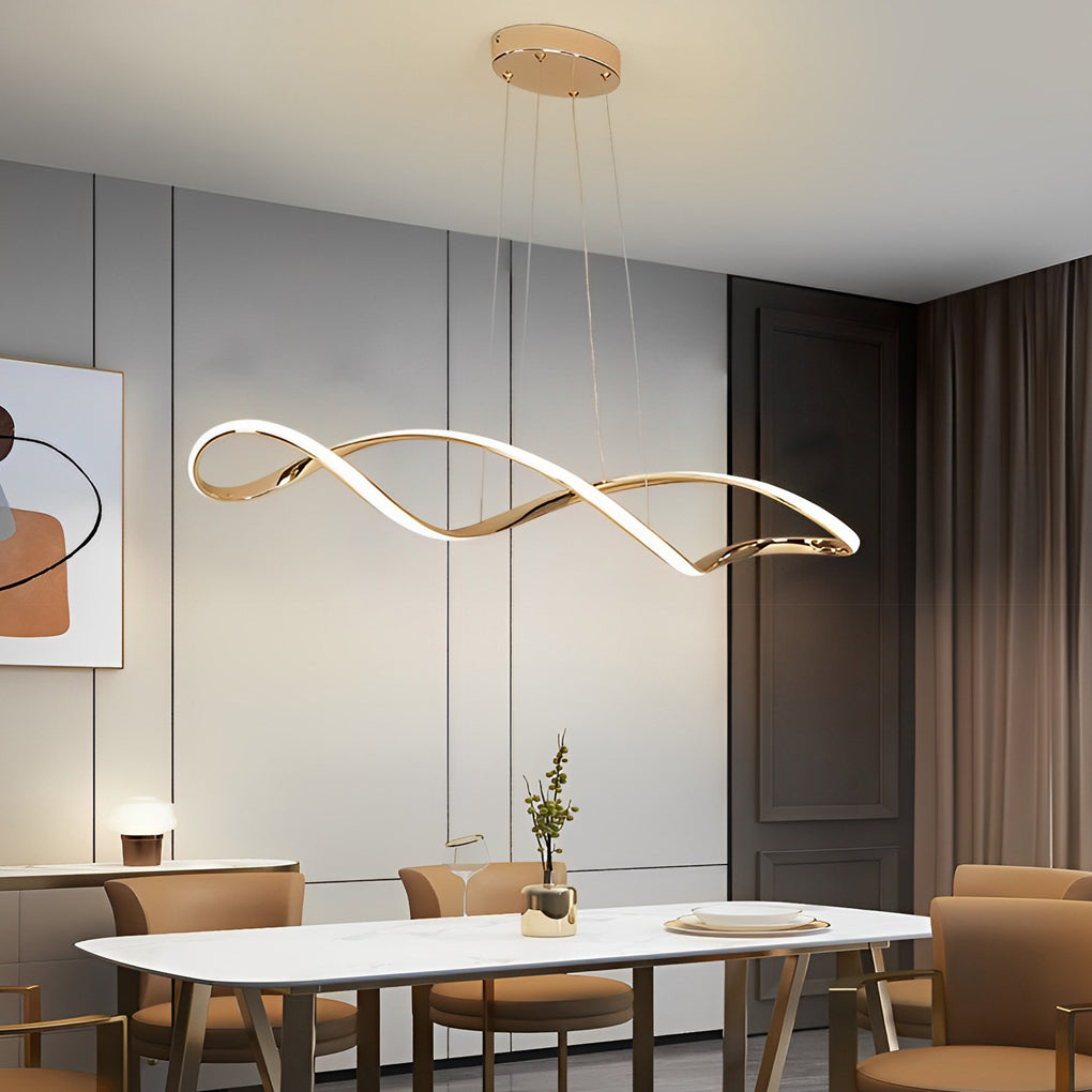 Waveform pendant light in gold finish illuminating modern dining area with artwork.