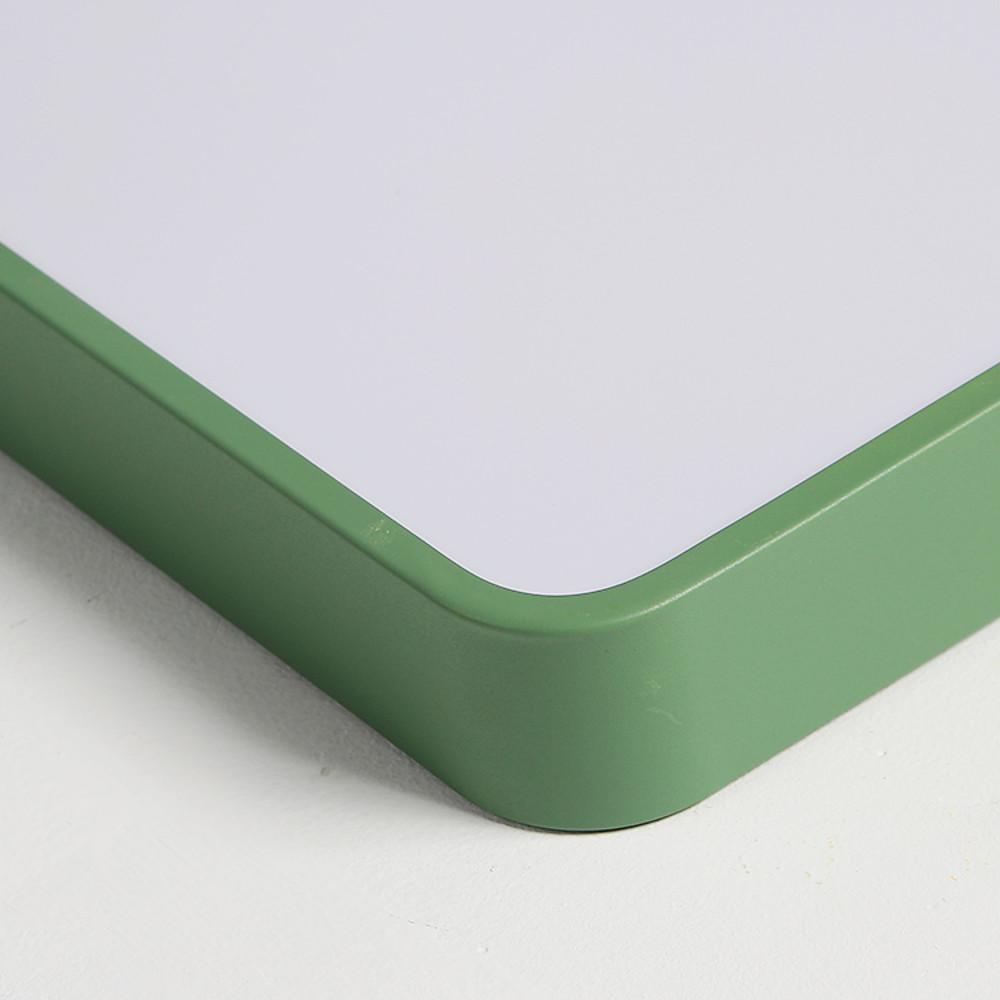 Green square ceiling light frame detail with rounded edge design.