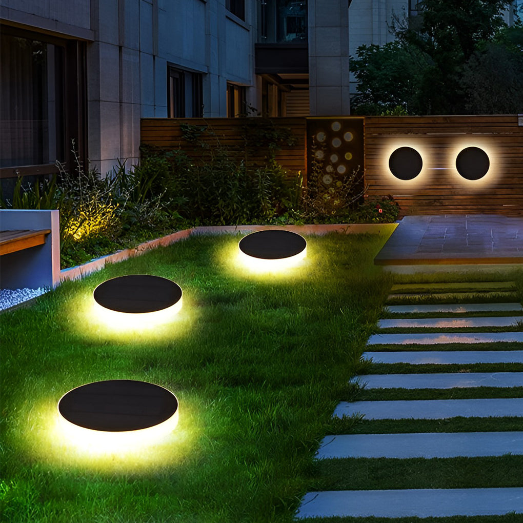 Ground solar lights providing elegant illumination for a contemporary garden.