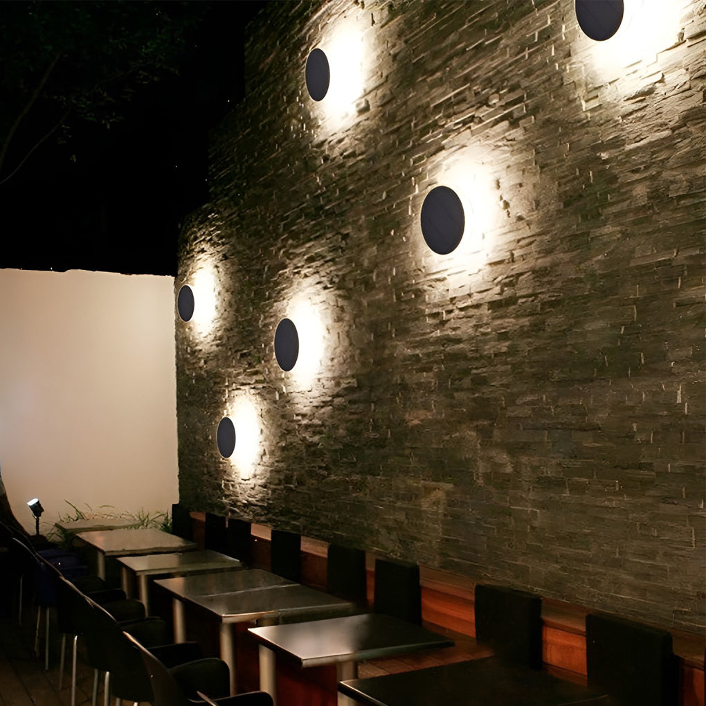 Ground solar lights illuminating a cozy outdoor seating area with directional glow.