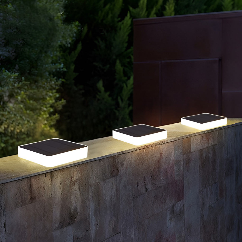 Ground solar lights illuminating a minimalist outdoor deck with focused glow.