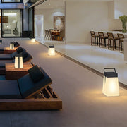 Hanging solar lantern lights placed along a modern outdoor lounge area, creating soft ambient illumination for evening relaxation.