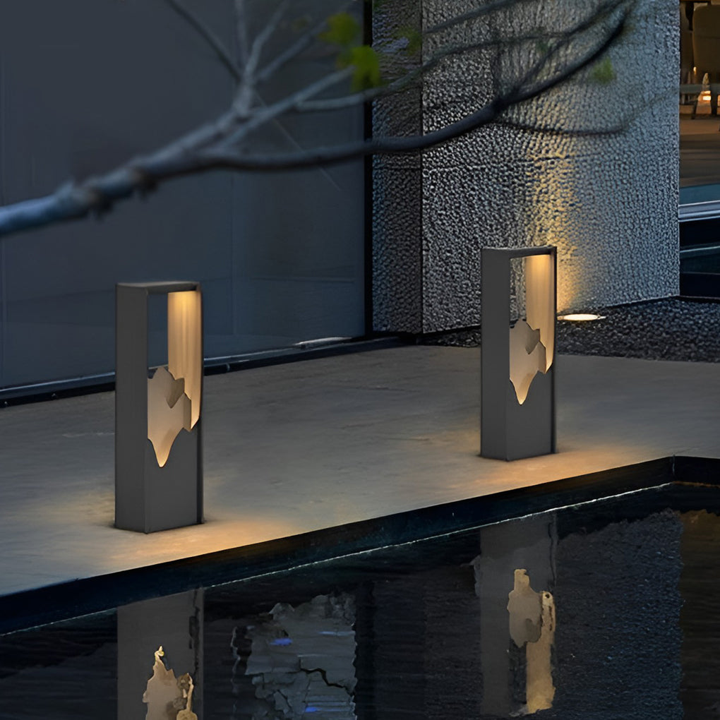 Hollow lawn lamp illuminating a contemporary garden with ambient glow.