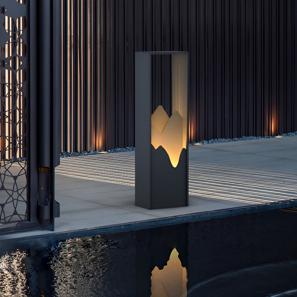 Hollow lawn lamp illuminating a modern fence with soft glow.