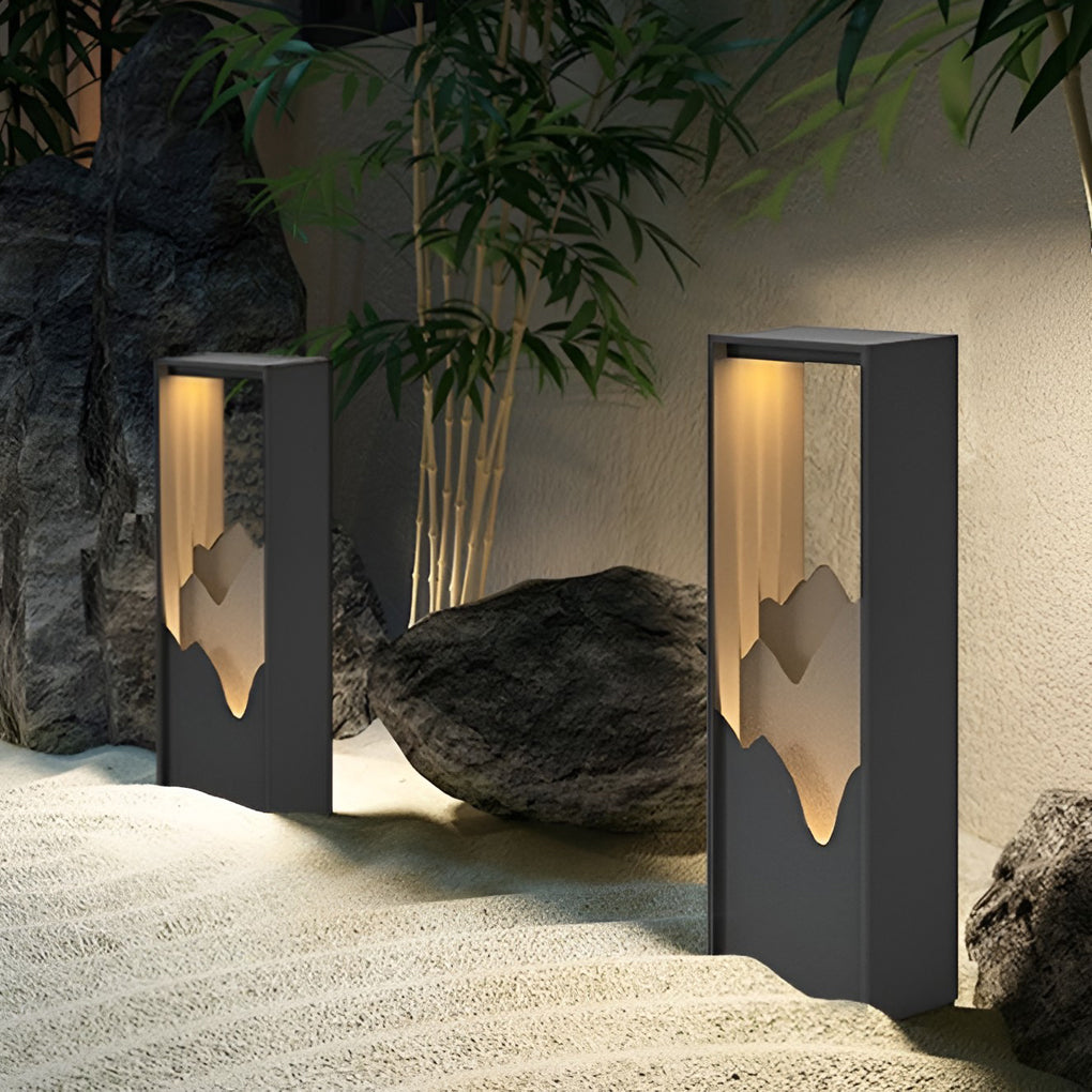 Hollow lawn lamp with mountain-cut design, providing elegant illumination along a pathway.
