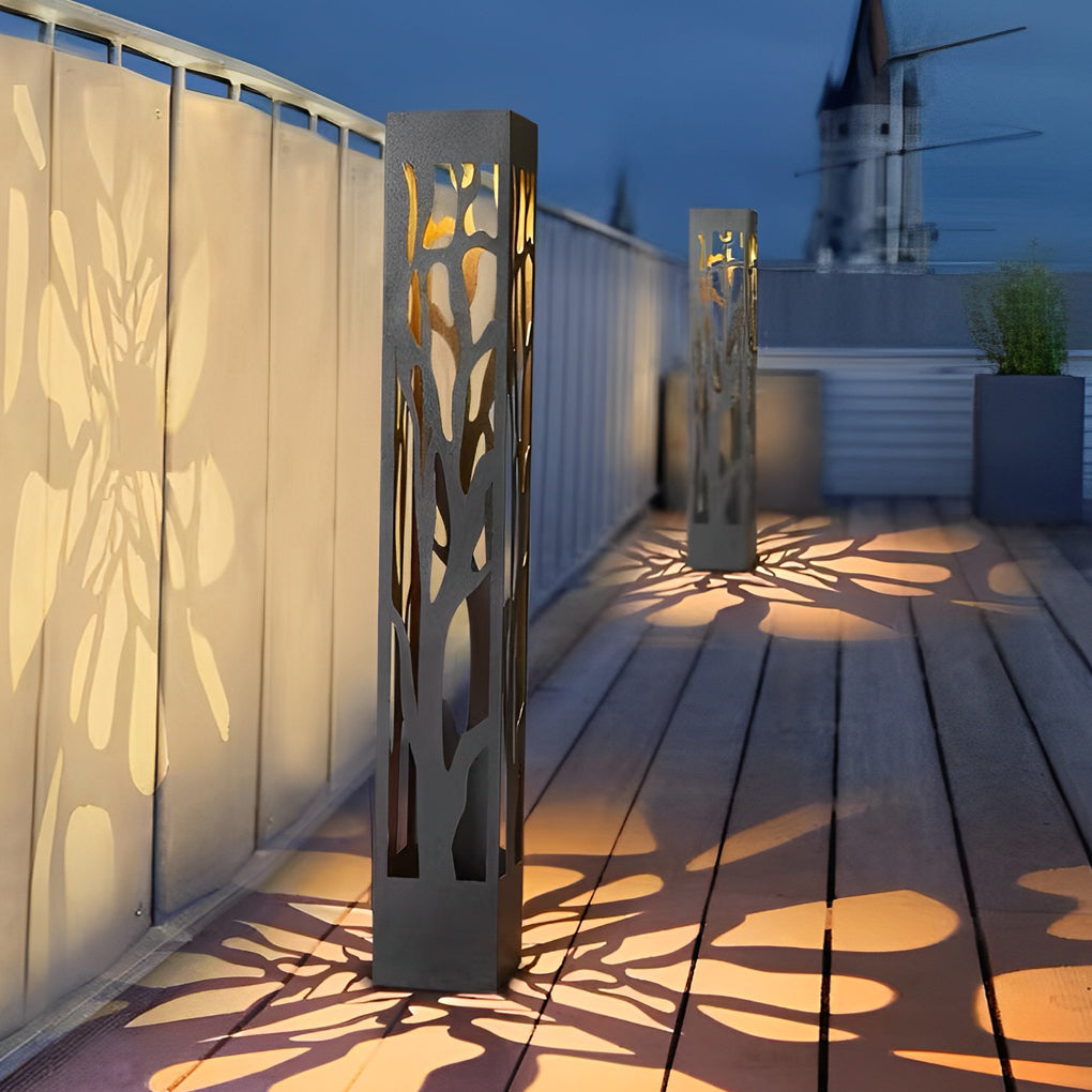 Hollow outdoor landscape lighting placed along wooden deck walkway with patterned light projection.