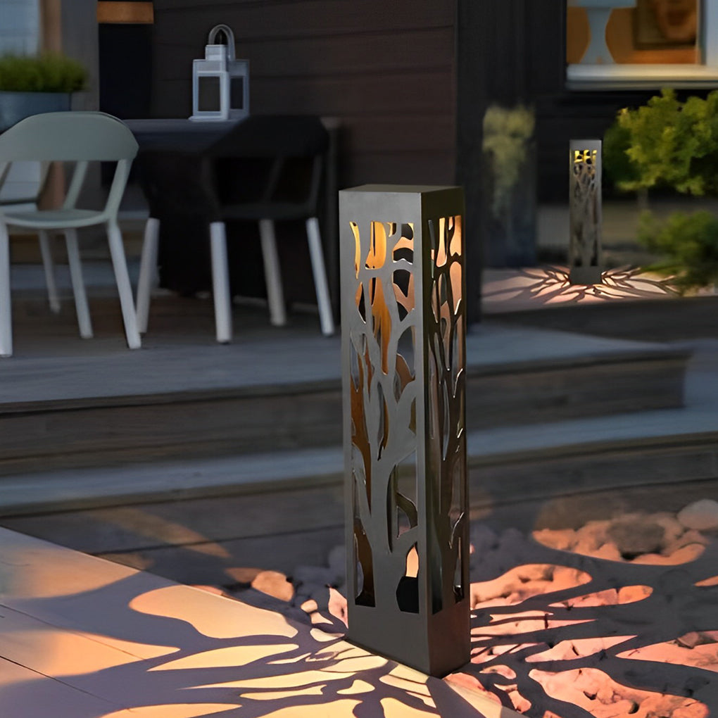 Hollow outdoor landscape lighting positioned near patio seating area for ambient night lighting.