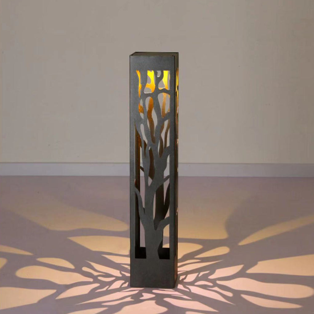 Single hollow outdoor landscape lighting product shown creating floral shadow on ground.