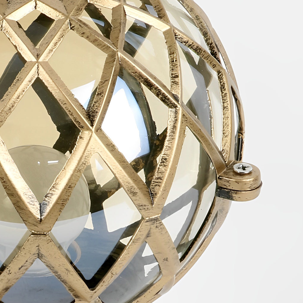 Home pillar light with a gold geometric sphere, displayed against a natural background to highlight its design.