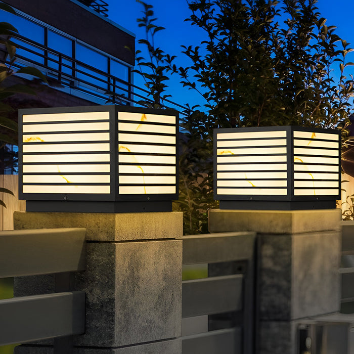 Home pillar light installed on outdoor gate posts at night