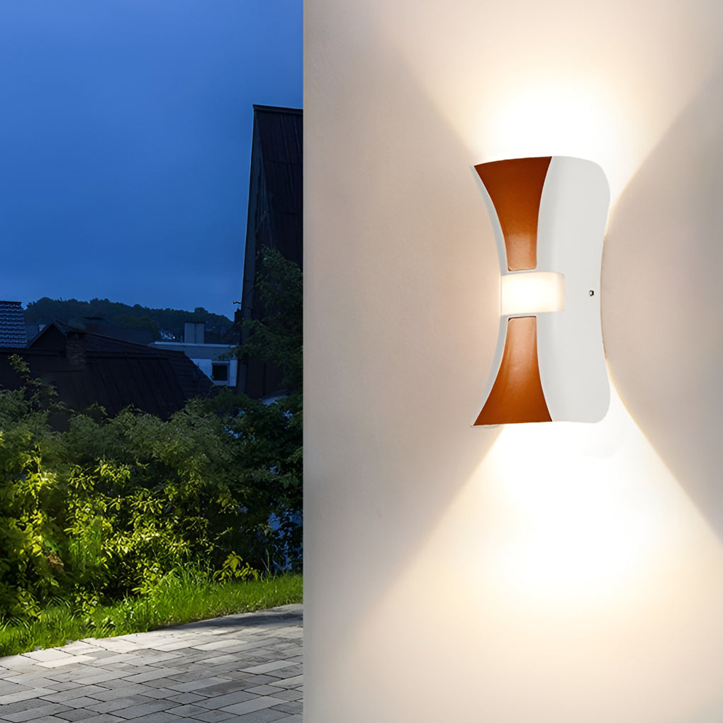 Hourglass wall light providing elegant illumination for a contemporary garden.