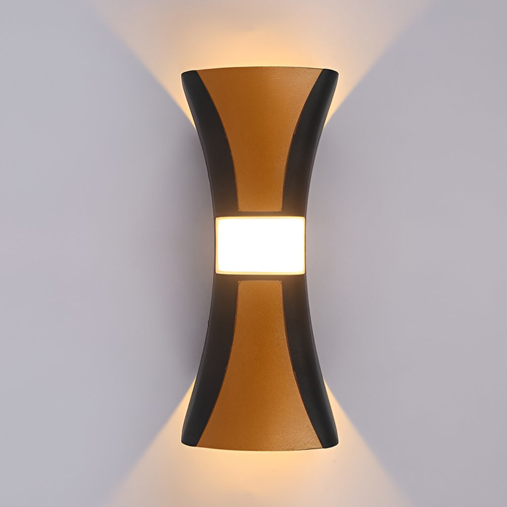 Hourglass wall light with detailed view of its copper and black finish.