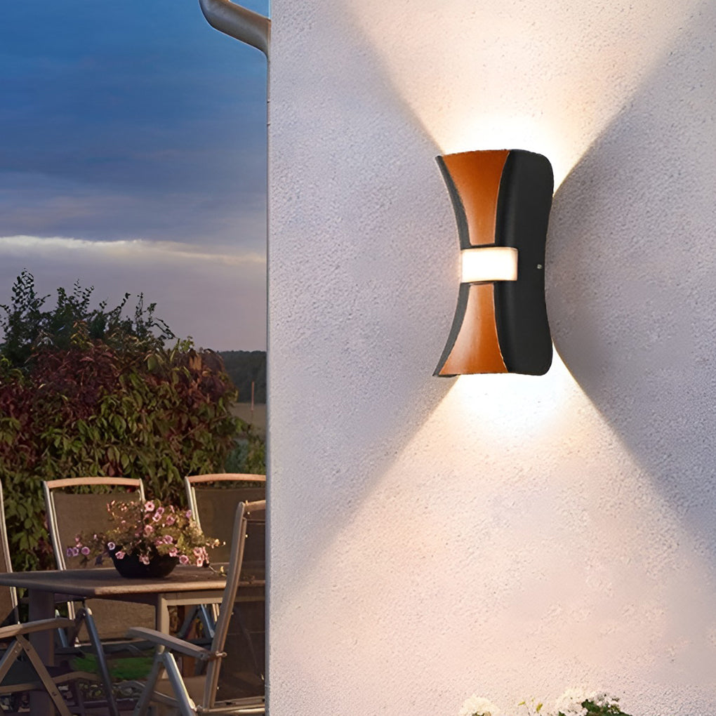 Hourglass wall light illuminating a cozy outdoor deck with directional glow.