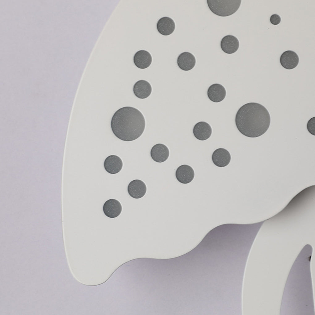 Jellyfish wall light perforated metal detail with circular cutouts.