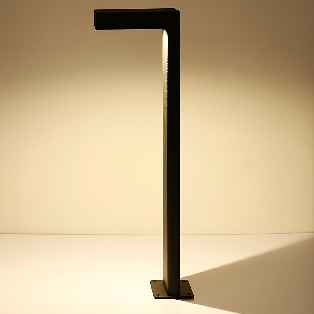 L shaped landscape light with a black frame, providing soft illumination on a garden path.