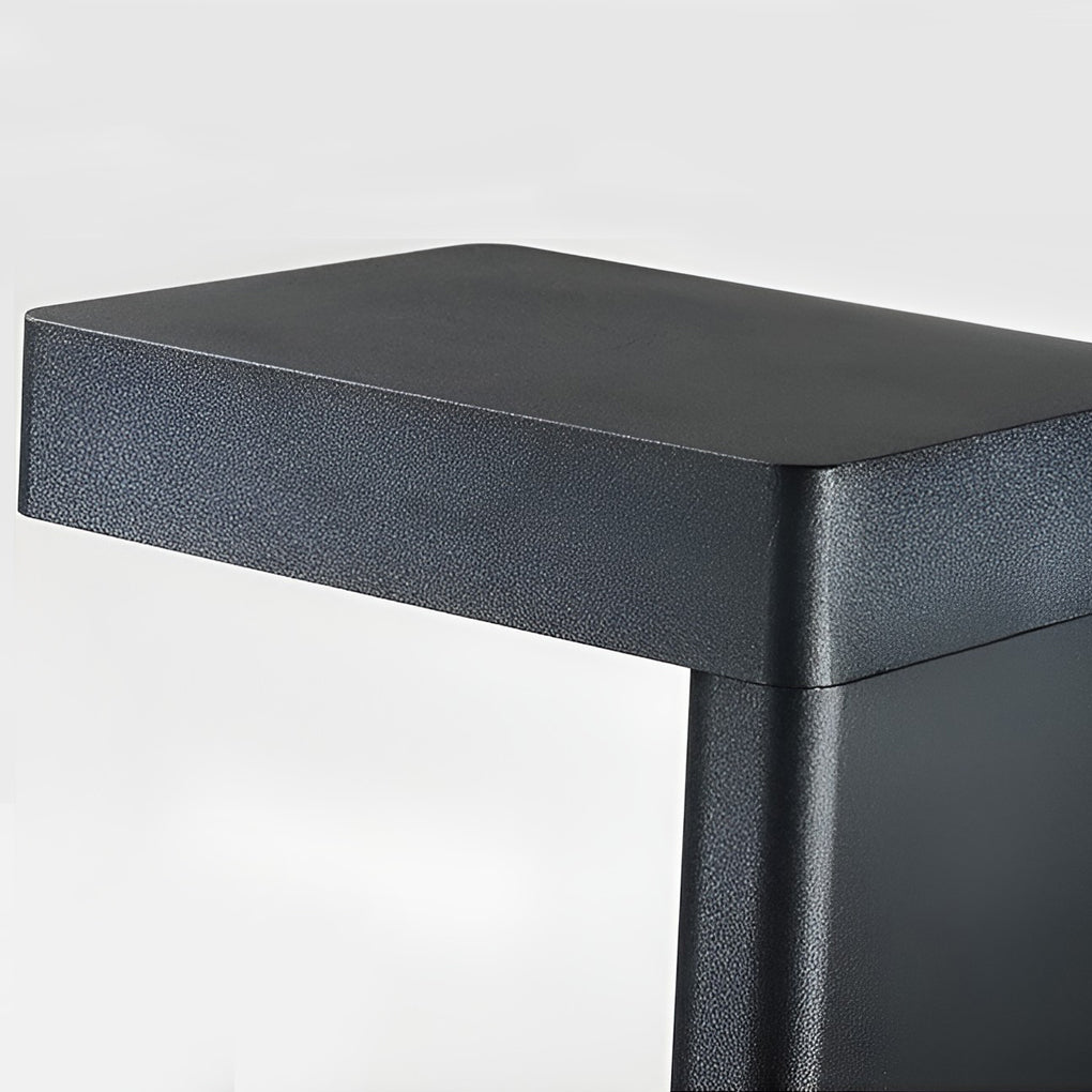 L shaped landscape light with a black finish, highlighting its top and light source.