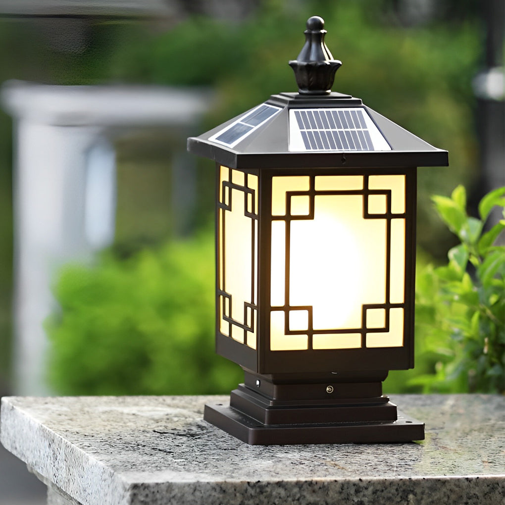 Lantern pillar lights mounted on a low stone post along a garden pathway.