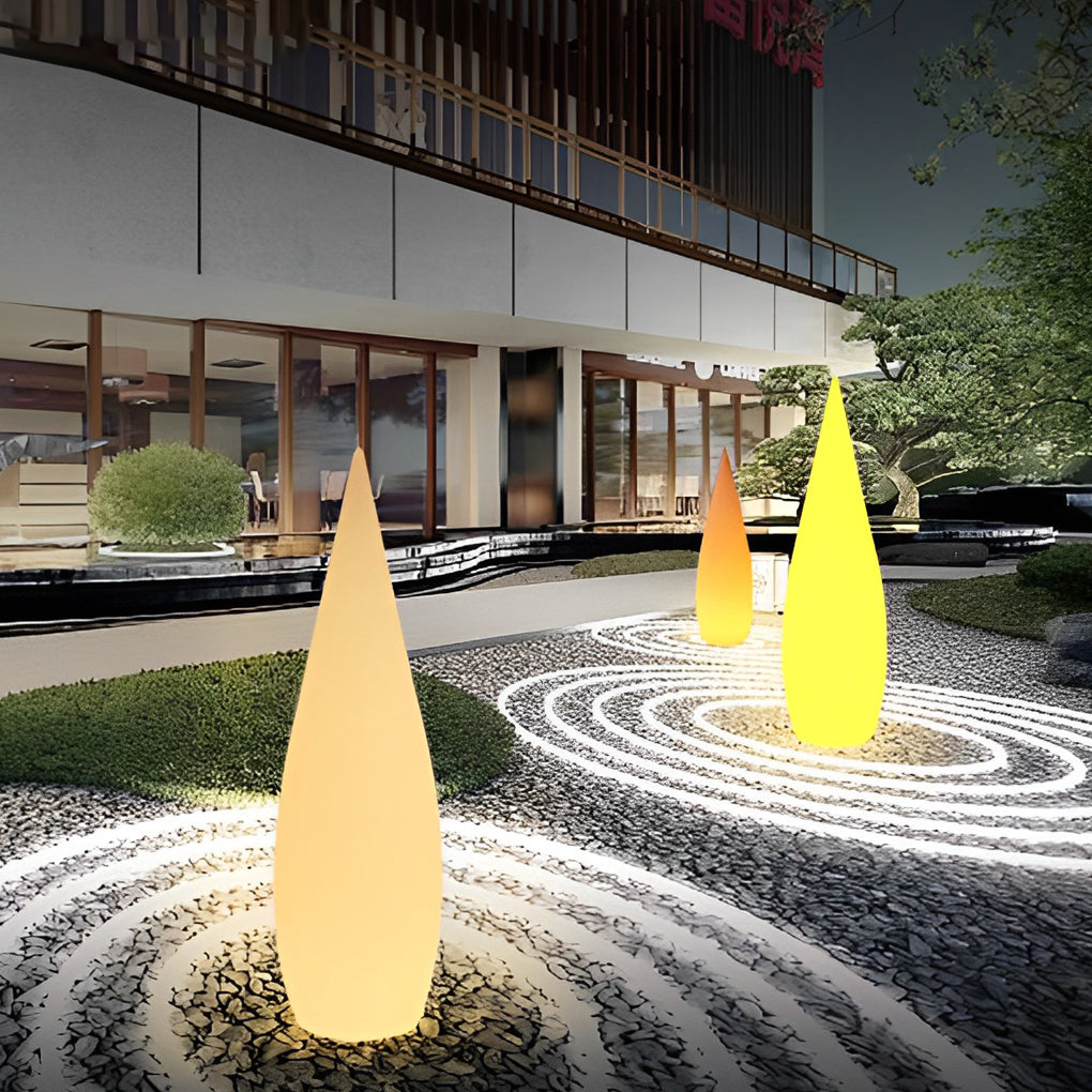 Large modern teardrop outdoor lamp used as architectural garden accent lighting.