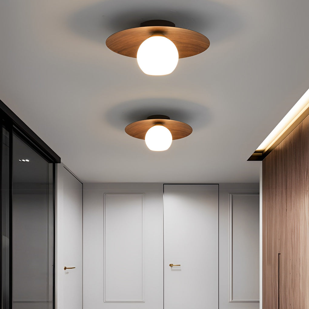 LED ceiling light with wood grain interior, providing ambient lighting in a contemporary home.