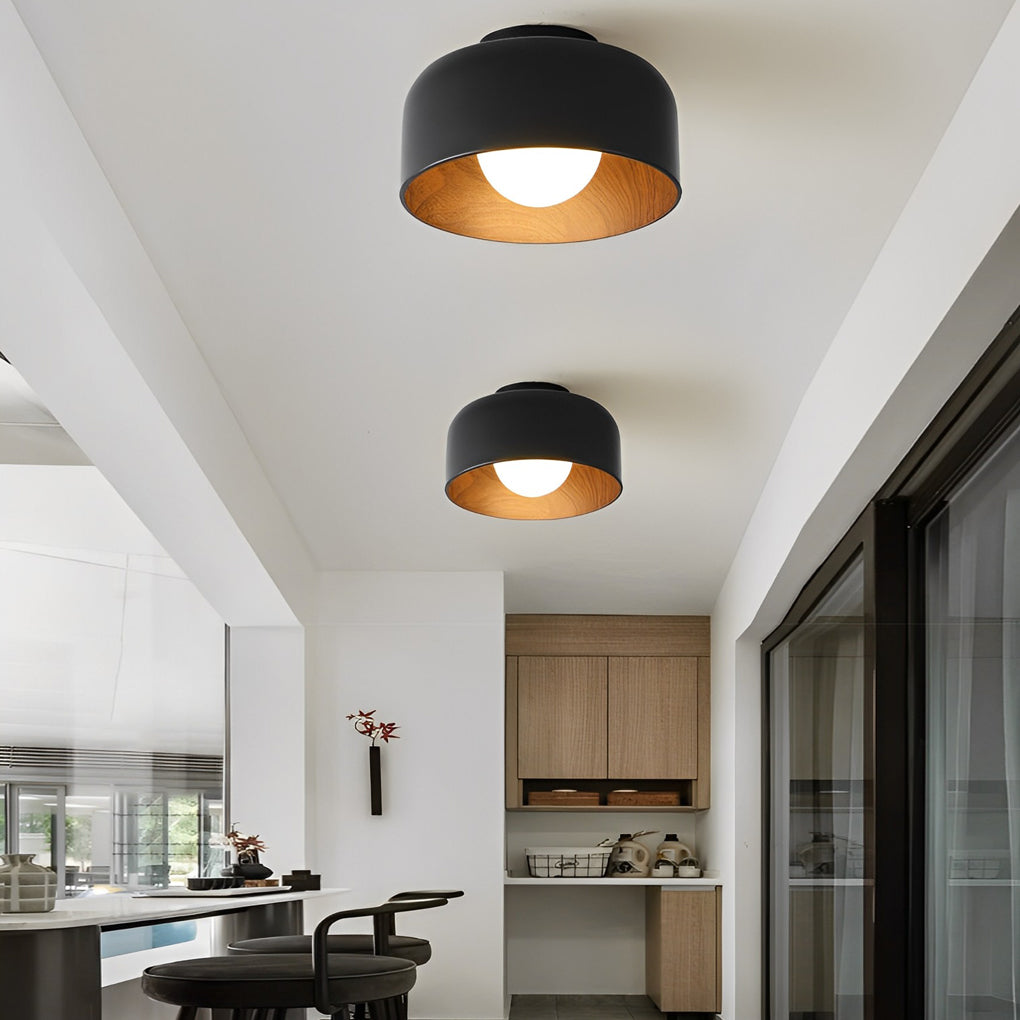 LED ceiling light with wood grain accents, casting warm light in a modern interior space.