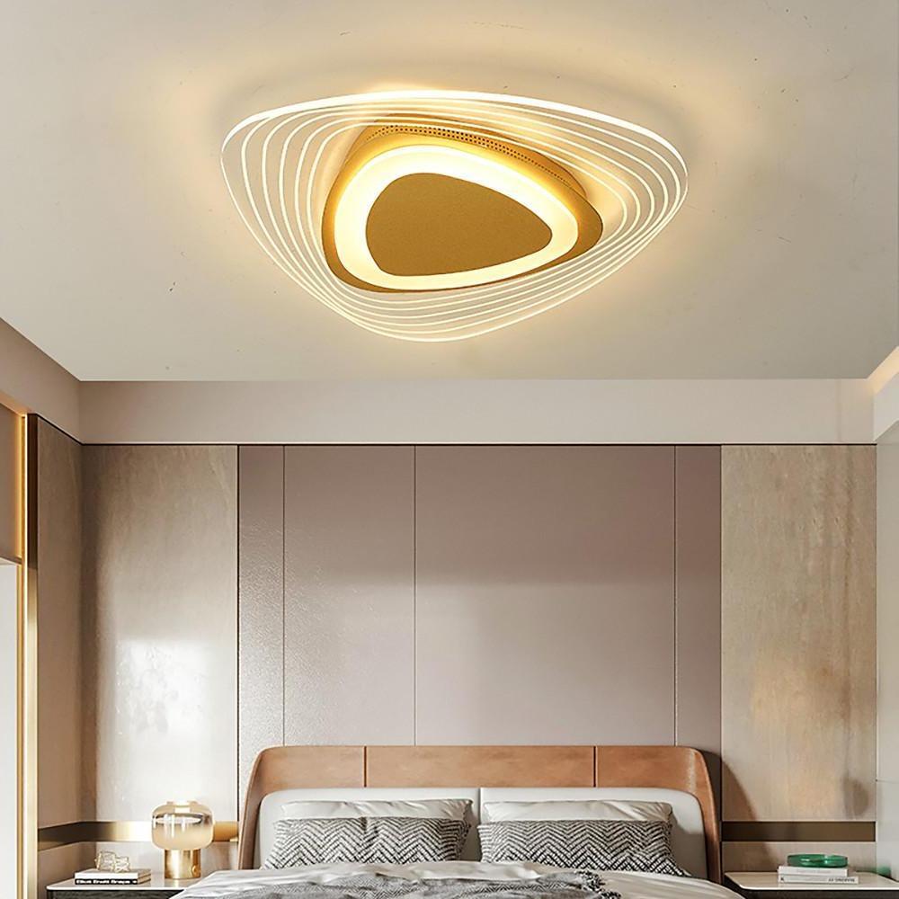 Triangle led ceiling lights creating soft layered lighting in a minimalist bedroom.