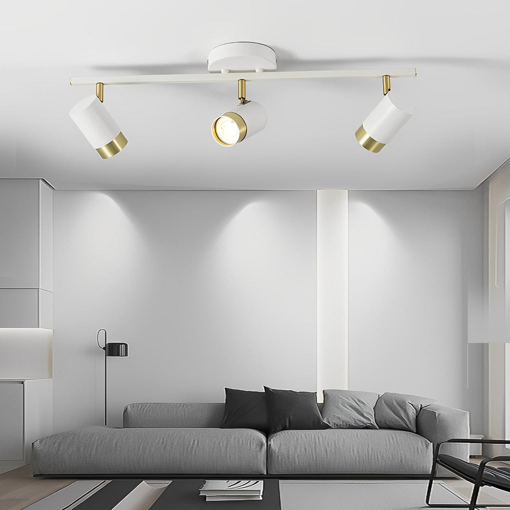 LED ceiling track spotlights with a black and gold finish, providing focused lighting in a bedroom.