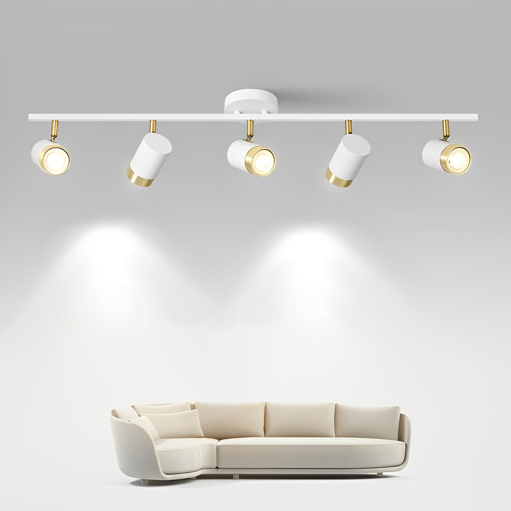 LED ceiling track spotlights with a gold and white finish, providing soft lighting in a living room.