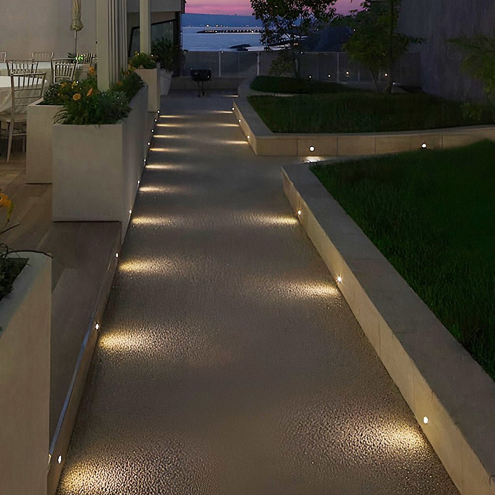 LED ground lights outdoor providing soft illumination along a stylish garden walkway.