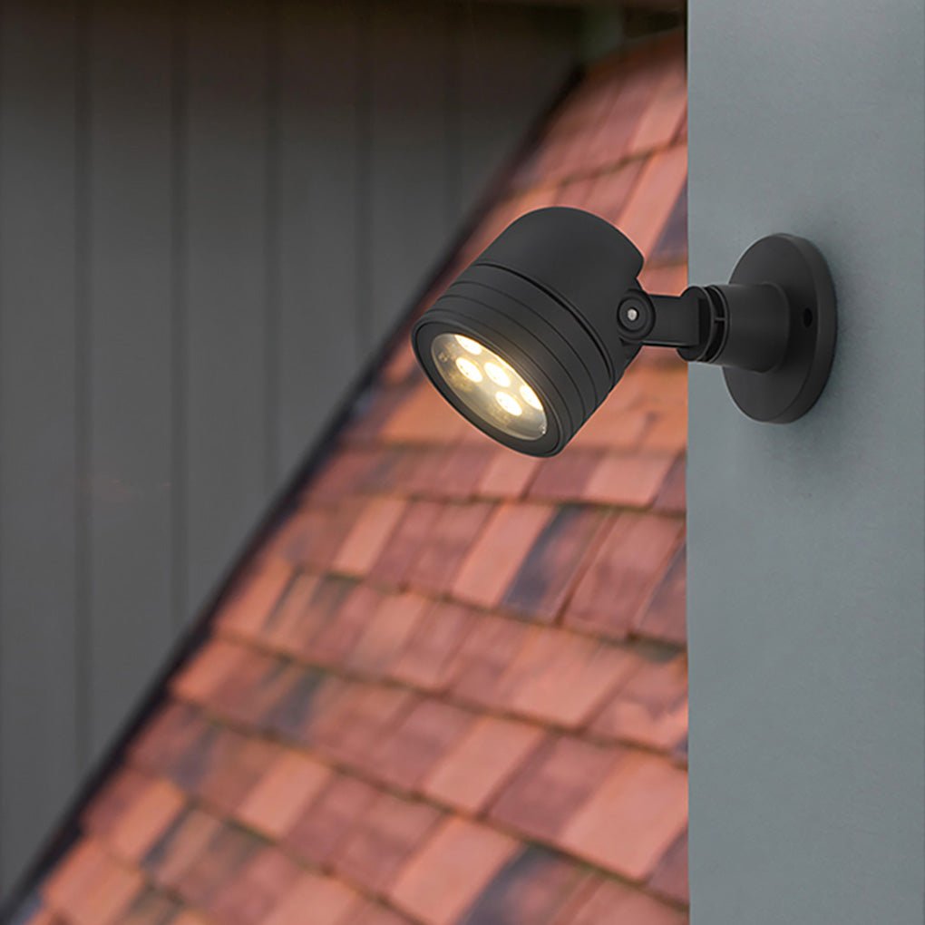 Wall-mounted LED landscape spot lights highlighting exterior siding and roof details with focused directional light.