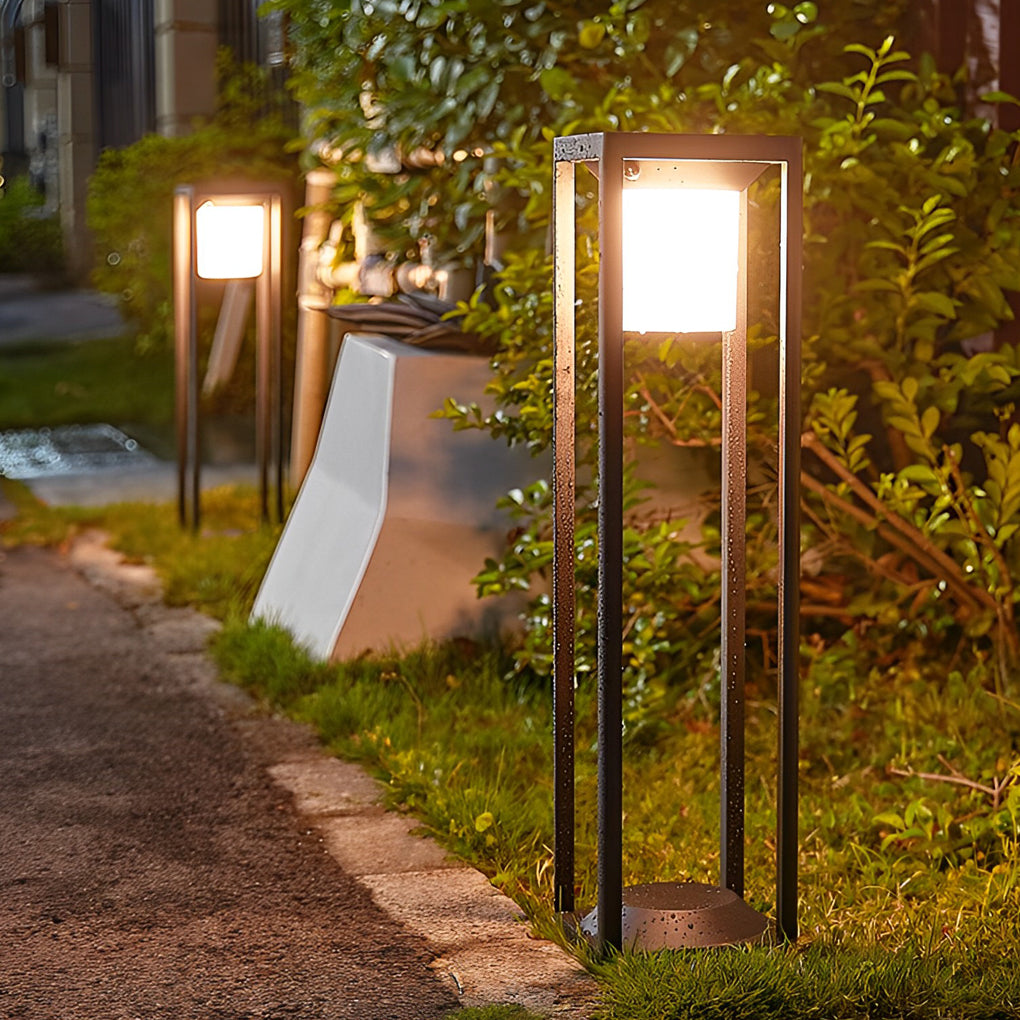 LED solar bollard lights providing warm light beside a gravel pathway.