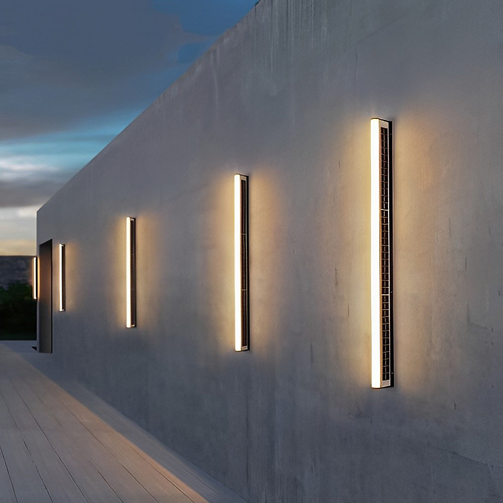 Two LED wall solar lights mounted on an exterior wall, casting bright vertical light beams.