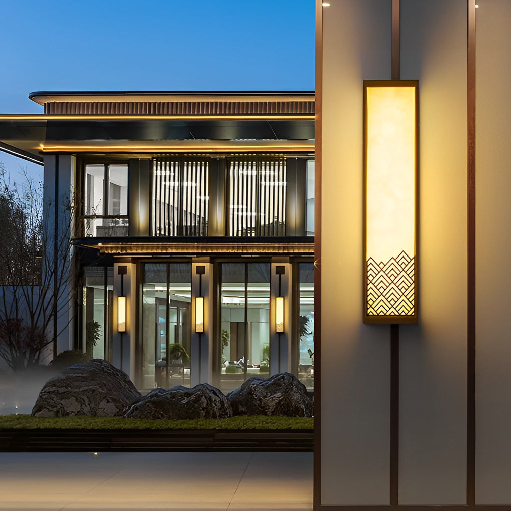 Lightbox wall lamp casting a gentle glow near a modern building facade.