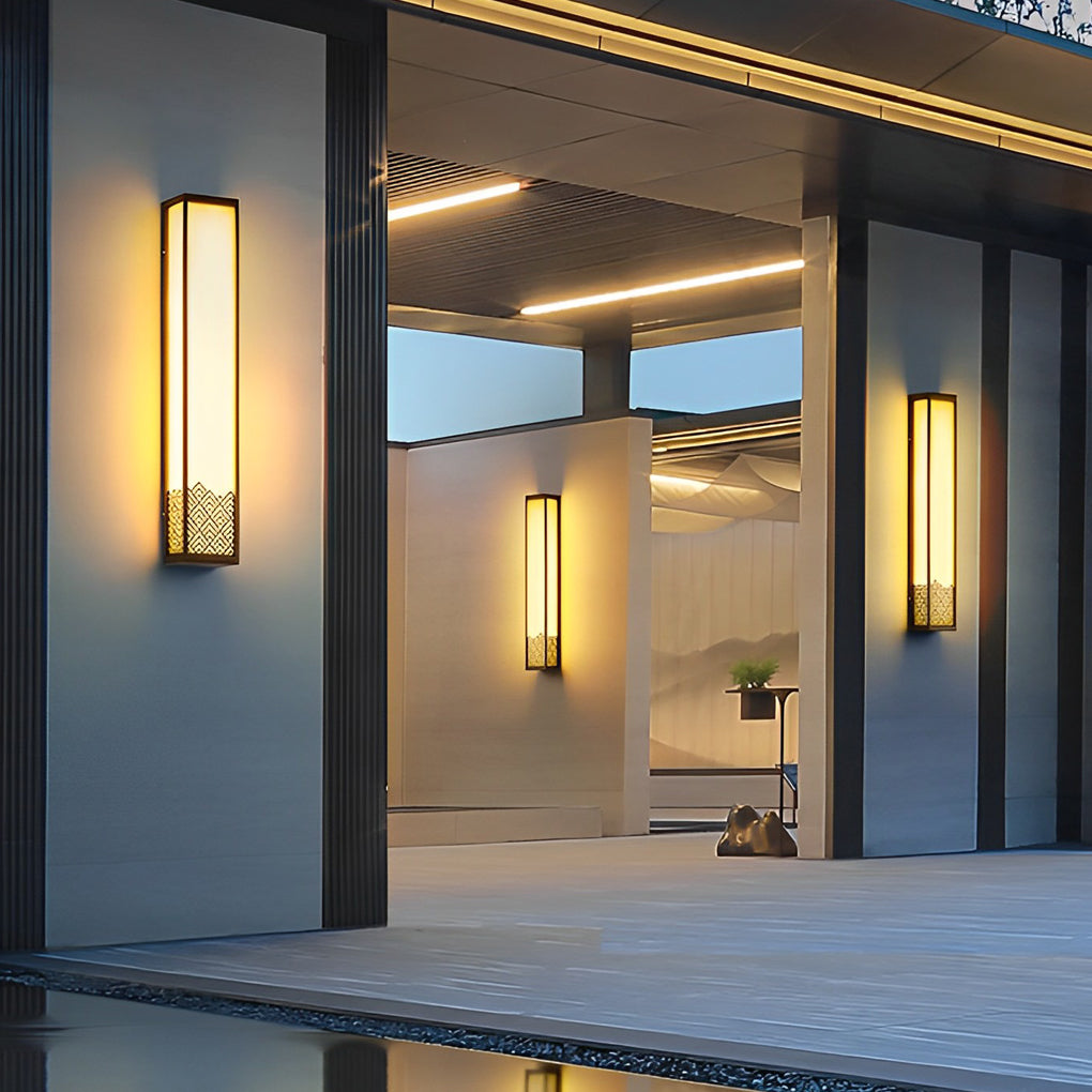 Lightbox wall lamp providing warm light beside a decorative sculpture.