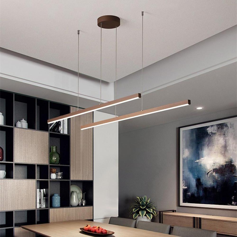 Linear pendant light fixture suspended over dining table in contemporary home.
