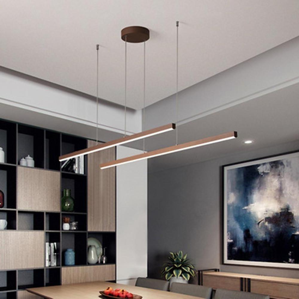 Contemporary linear pendant light fixture above living room table.