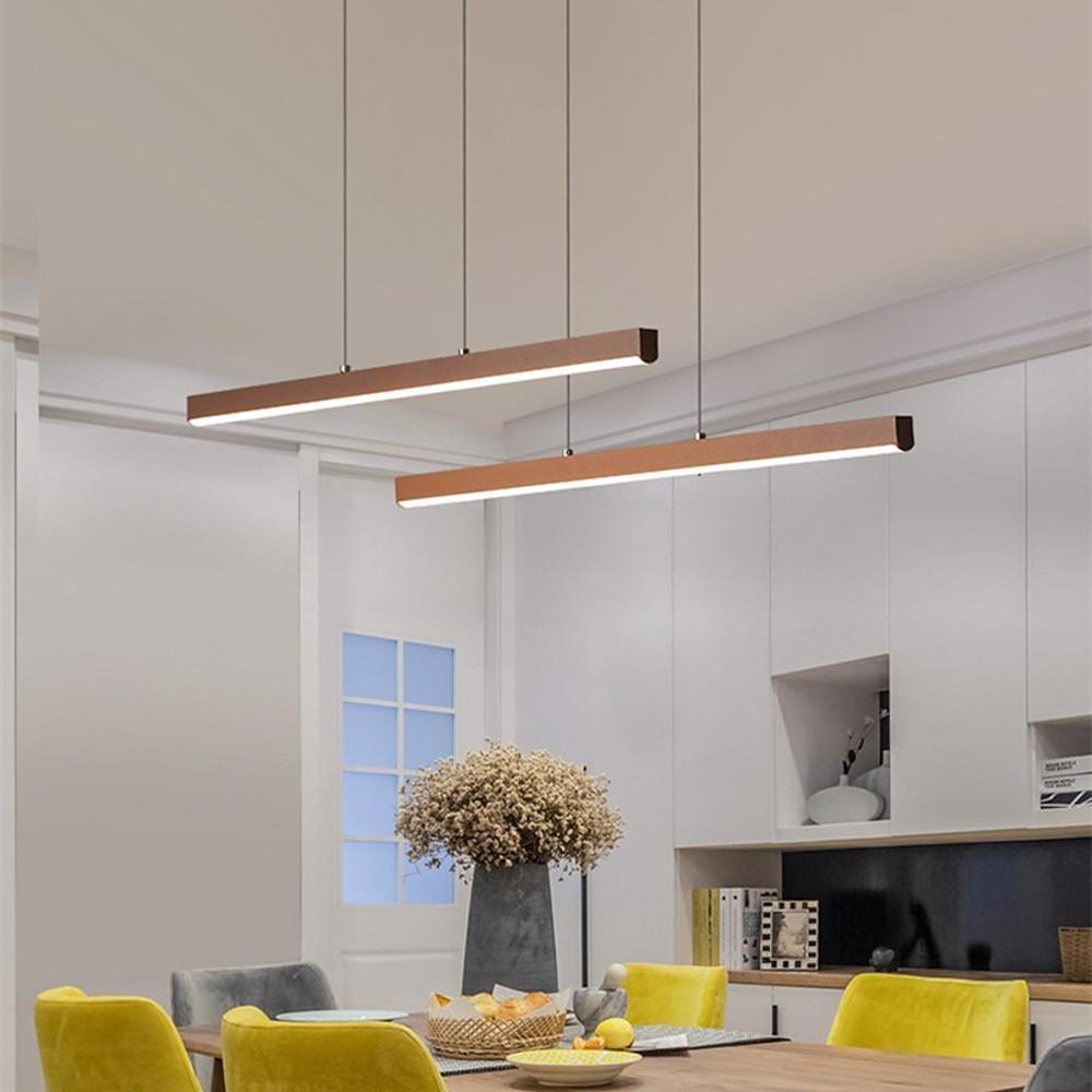 Linear pendant light fixture above dining table with open living space.