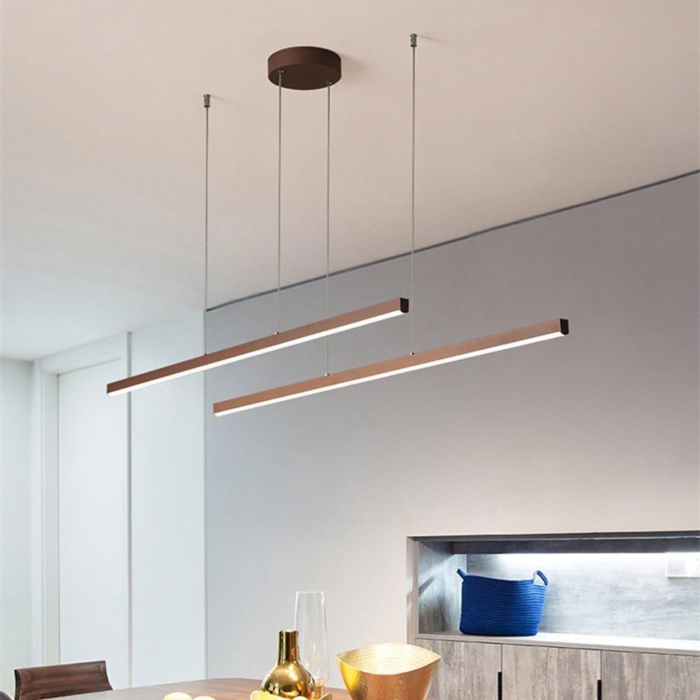 Double linear pendant light fixtures installed above dining table.