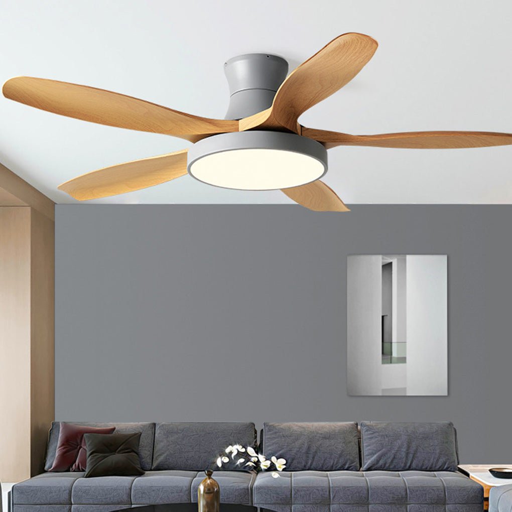 Minimalist living room ceiling fan with lights above a gray sofa, showcasing clean lines and natural wood-tone fan blades.