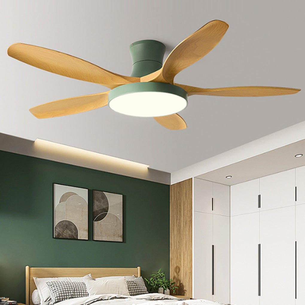 Living room ceiling fan with lights in a modern bedroom-living hybrid space, combining wooden blades and a green motor housing.