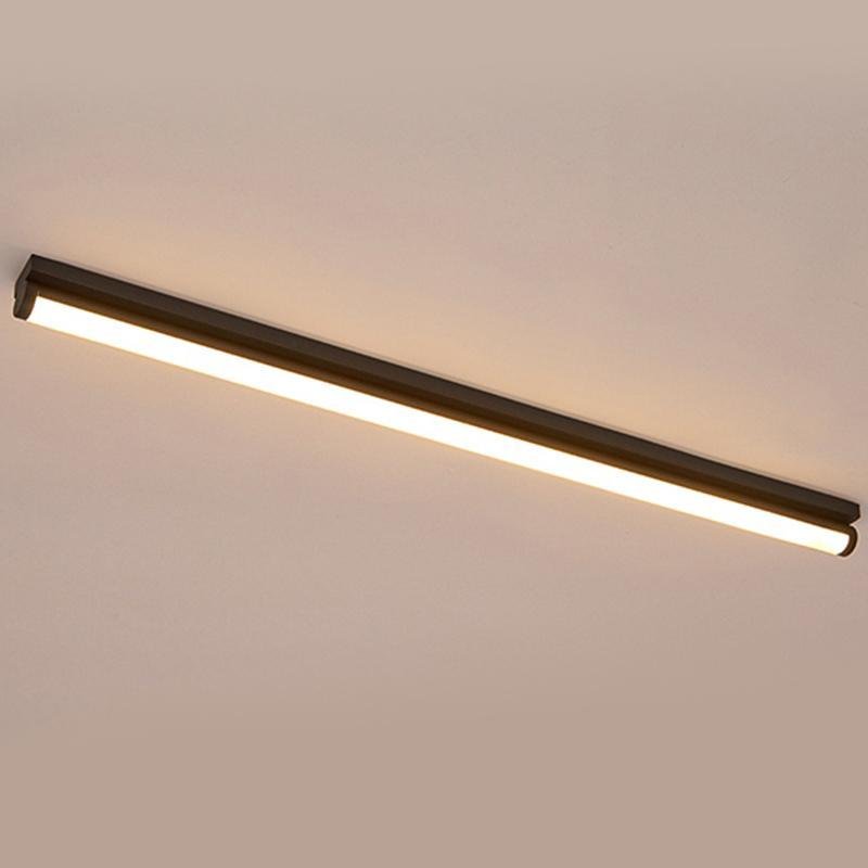 Long strip ceiling light providing ambient lighting in a contemporary living room.