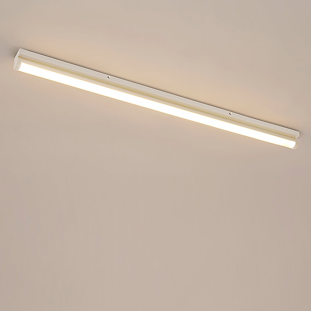 Long strip ceiling light with a modern design, providing warm illumination.