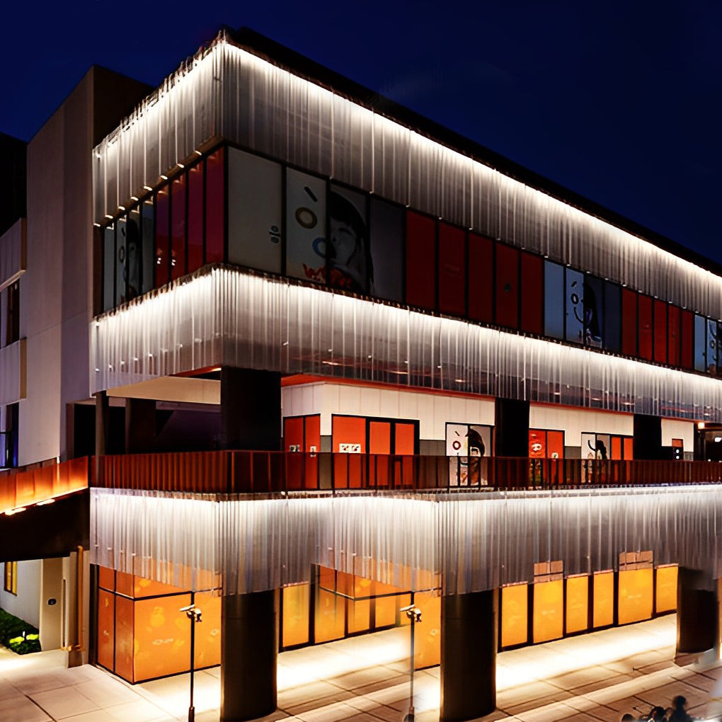 Low voltage wall wash light illuminating the exterior of a contemporary building, enhancing architectural details at night.