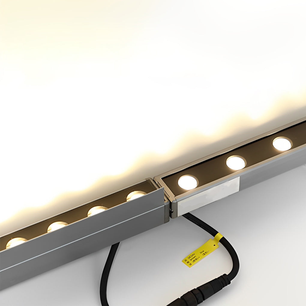 Close-up of a low voltage wall wash light fixture, showcasing its compact design and LED light points.