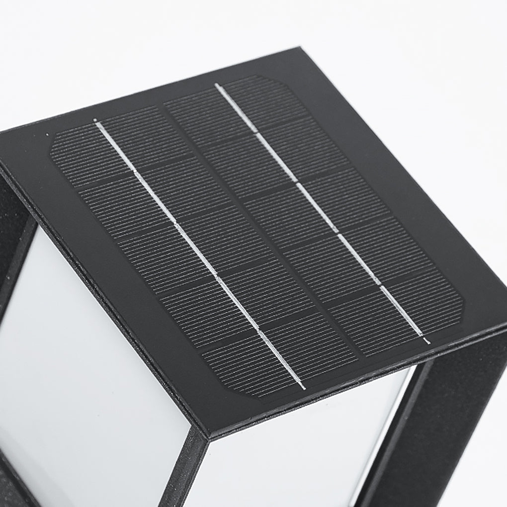 Close up detail of a solar panel top on black outdoor bollard lights against white background.