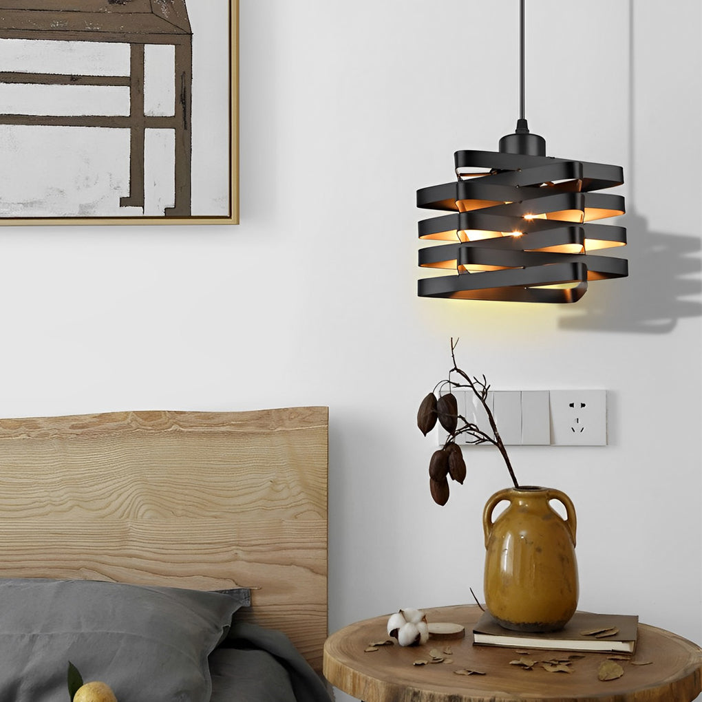 Metal ribbon pendant light used as bedside accent lighting.