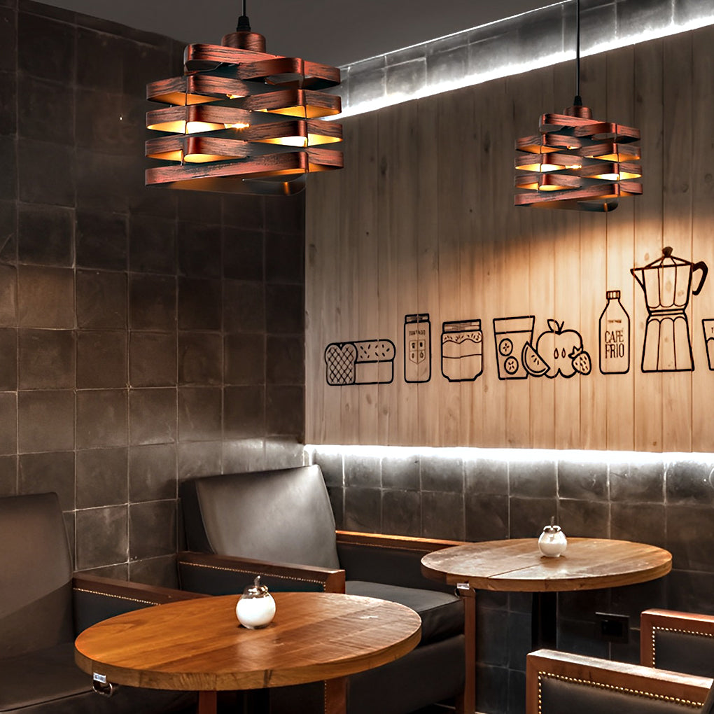 Metal ribbon pendant lights illuminating restaurant seating area.