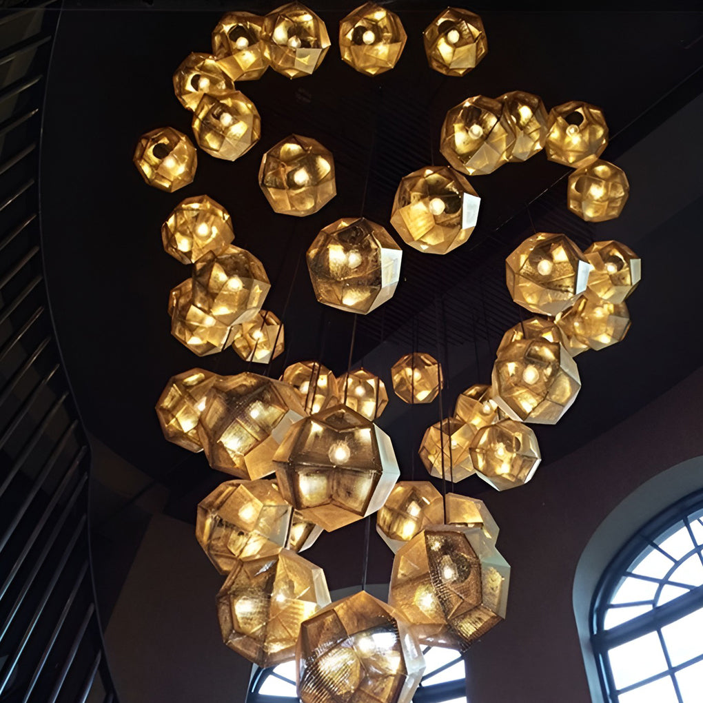 Artistic metal shade pendant light installation arranged in a flowing cluster pattern inside a modern venue.